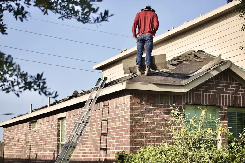 Professional roofer working on a residential roof in Villages of Zinfandel
